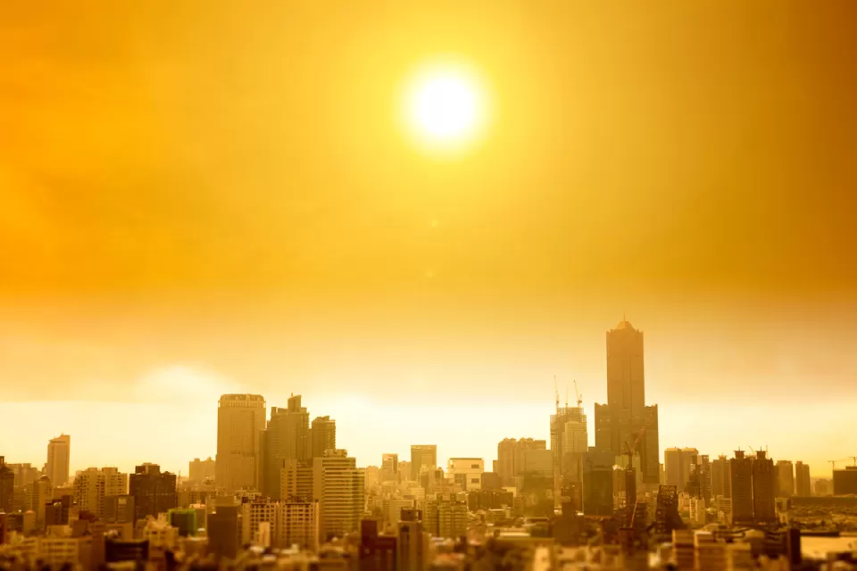 View of hazy city skyline in yellow smog indicating extreme heat.
